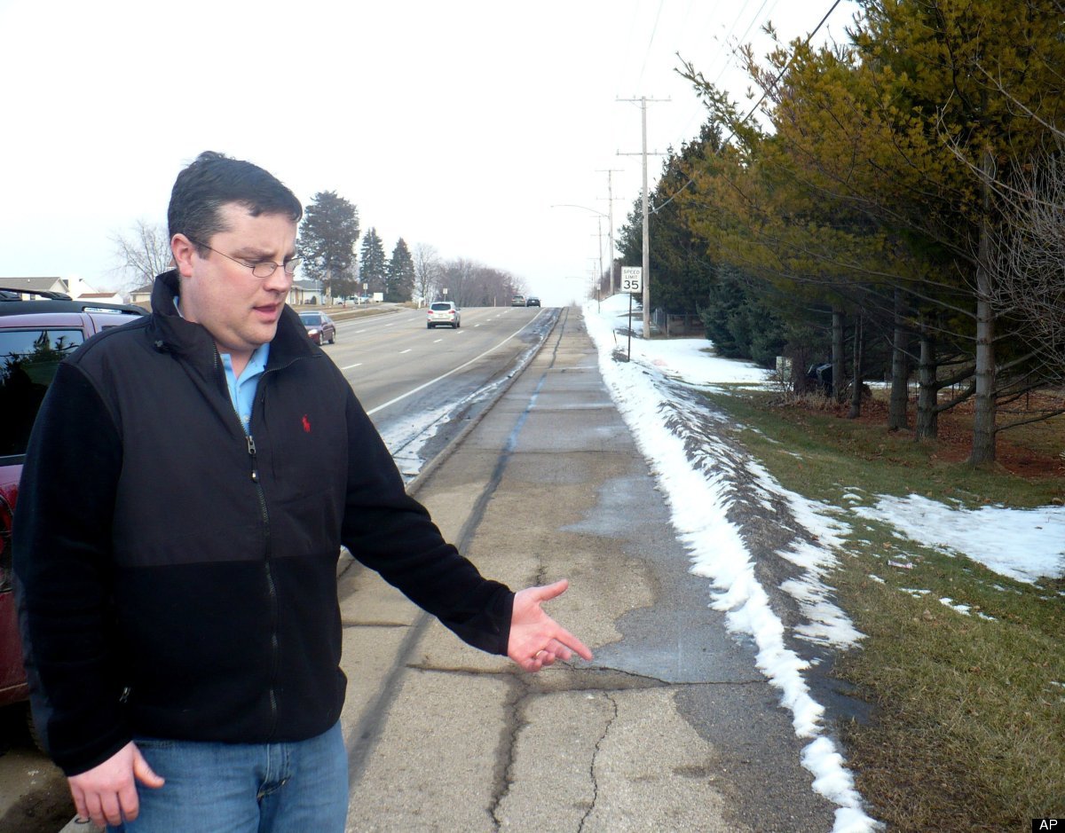 Mike Vega points to the area of sidewalk in Madison, Wis., Wednesday, Feb. 15, 2012, where he discovered a starving 15-year-o