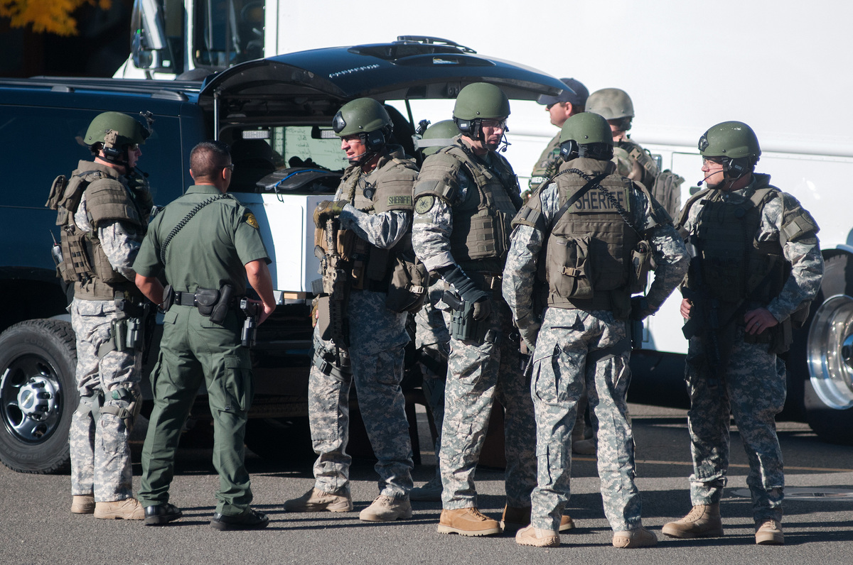 Swat team members secure the scene near Sparks Middle School in Sparks, Nev., after a shooting there on Monday, Oct. 21, 2013