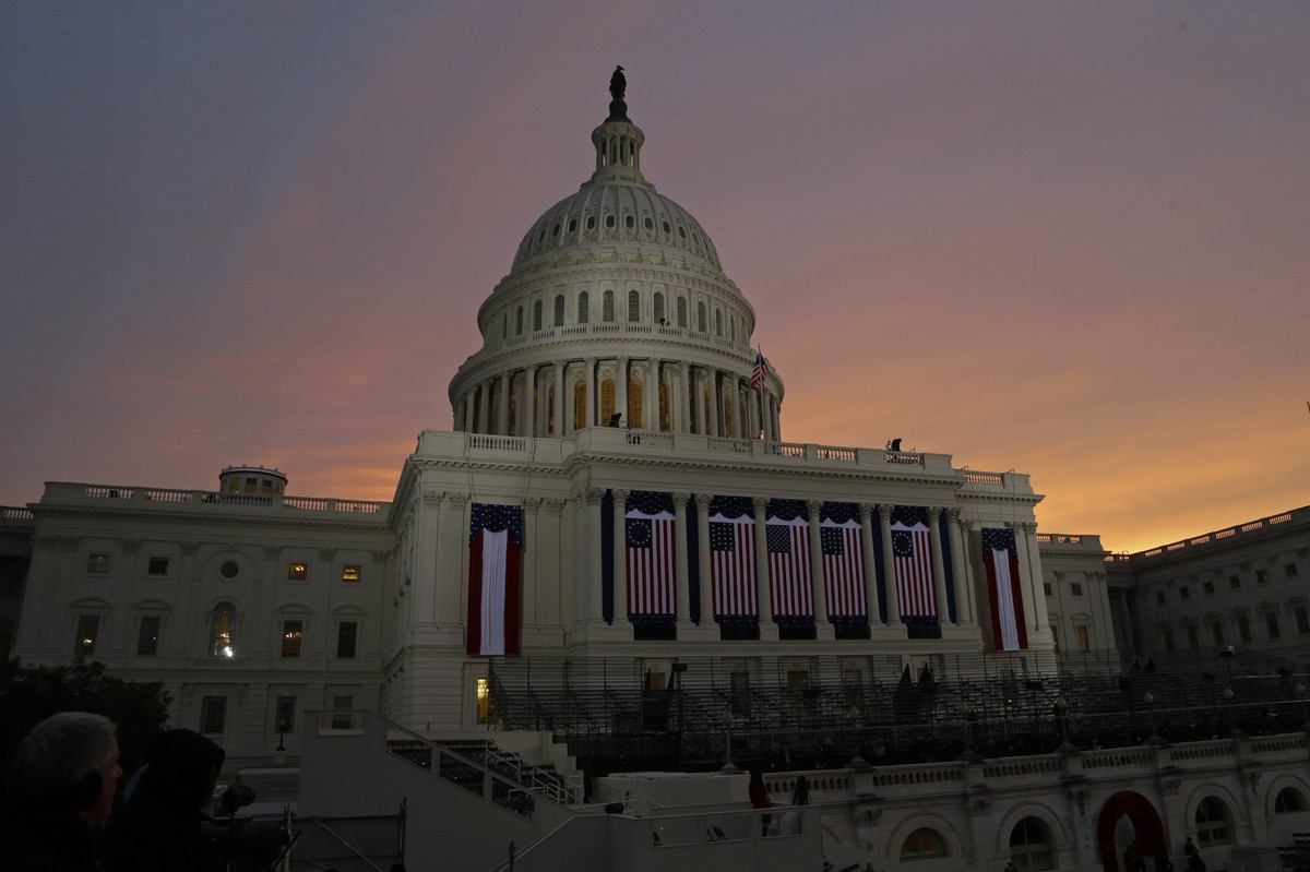 The sun rises behind the U.S. Capitol Dome early in the morning before the ceremonial swearing-in of President Barack Obama d