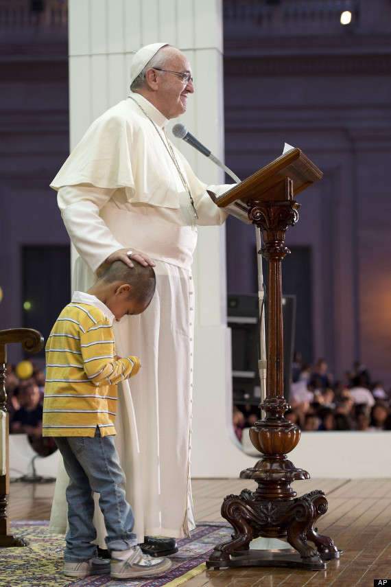 This adorable little boy was on top of the world when he made friends with Pope Francis by wandering up onto the stage during