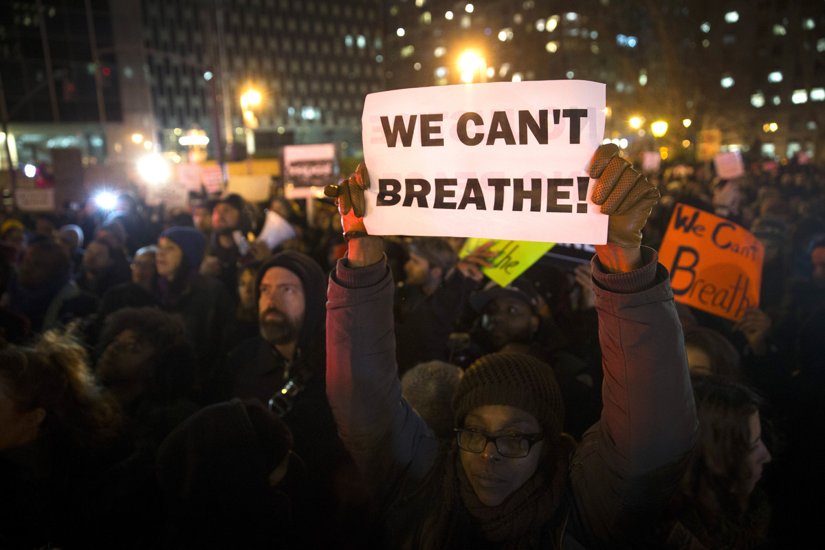 Demonstrators participate in a rally against a grand jury's decision not to indict the police officer involved in the death o