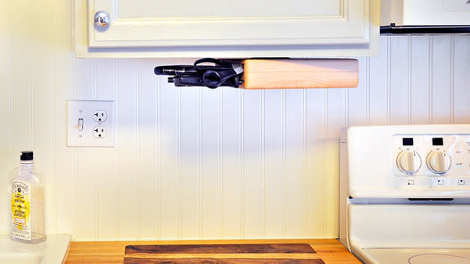 Skip the traditional large-knife block and hang a magnetic strip on the wall to store your knives. (If you have tiled walls, consider a compact butcher's block that attaches to the bottom of your upper cabinets.)