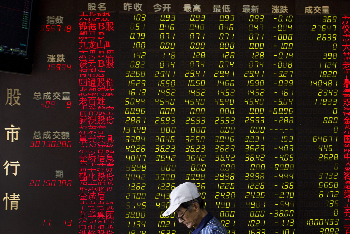 A man walks past an electric board displaying stock prices at a brokerage house in Beijing, China, Wednesday, July 8, 2015. C