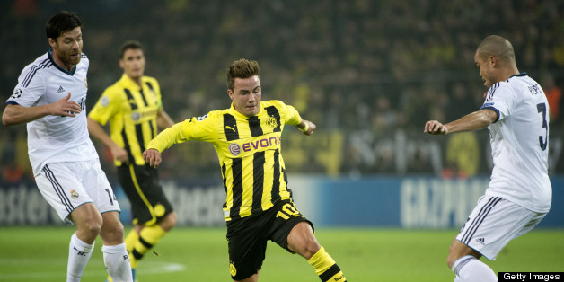 Dortmund's midfielder Mario Goetze (C) vies for the ball with Real Madrid's Portuguese defender Pepe (R) and Real Madrid's defender Sergio Ramos during the UEFA Champions League Group D football match BVB Borussia Dortmund vs Real Madrid in Dortmund, western Germany on October 24, 2012. AFP PHOTO / ODD ANDERSEN (Photo credit should read ODD ANDERSEN/AFP/Getty Images)