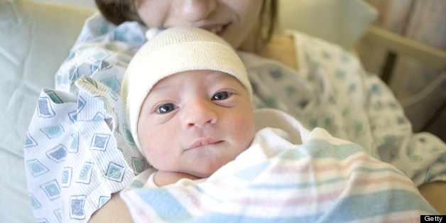 Newborn baby boy in mother's arms