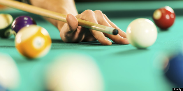 Unrecognizable person playing billiards.