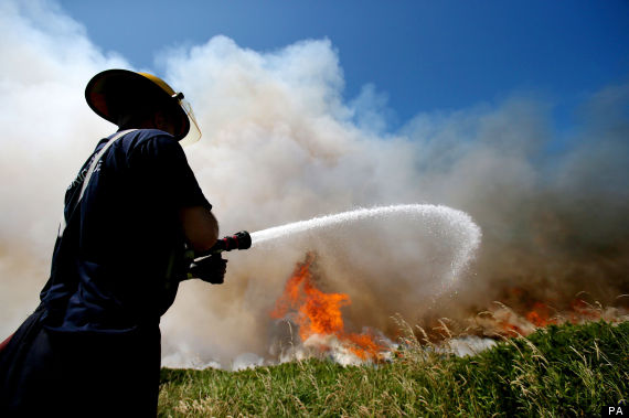 a firefighter battling a gorse blaze on howth head