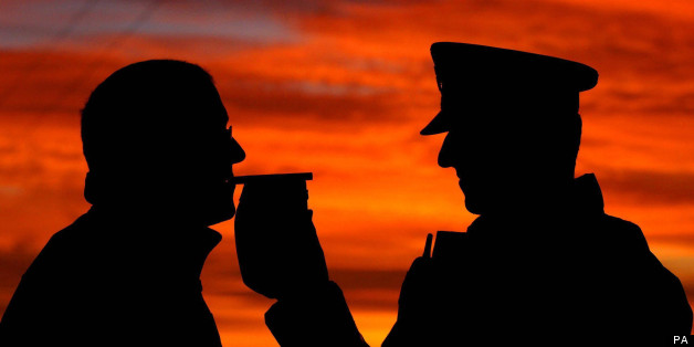 A motorist stopped by police taking a breath test