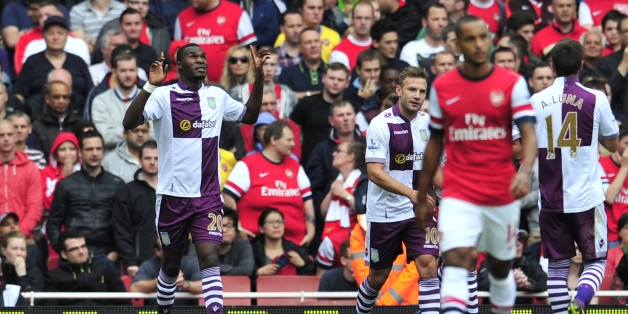 Aston Villa's Belgian striker Christian Benteke (L) celebrates scoring his team's first goal to equalise the score line during the English Premier League football match between Arsenal and Aston Villa at the Emirates stadium in North London on August 17, 2013. AFP PHOTO/GLYN KIRK == RESTRICTED TO EDITORIAL USE. NO USE WITH UNAUTHORIZED AUDIO, VIDEO, DATA, FIXTURE LISTS, CLUB/LEAGUE LOGOS OR LIVE SERVICES. ONLINE IN-MATCH USE LIMITED TO 45 IMAGES, NO VIDEO EMULATION. NO USE IN BETTING, GAMES OR