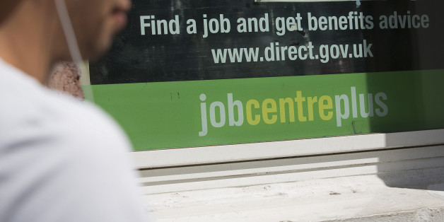 A pedestrian walks past a job centre in London, U.K., on Tuesday, Aug. 6, 2013. Bank of England governor Mark Carney will present a review tomorrow on implementing forward guidance in the U.K. as improving economic data boosts the future cost of money. Photographer: Simon Dawson/Bloomberg via Getty Images