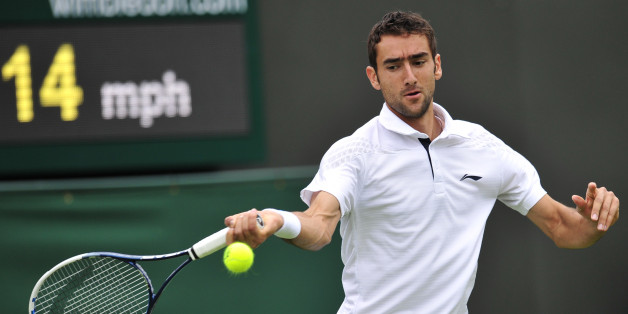 Croatia's Marin Cilic returns against Cyprus's Marcos Baghdatis on his way to victory in their men's first round match on day one of the 2013 Wimbledon Championships tennis tournament at the All England Club in Wimbledon, southwest London, on June 24, 2013. Cilic won 6-3, 6-4, 6-4. AFP PHOTO / GLYN KIRK - RESTRICTED TO EDITORIAL USE (Photo credit should read GLYN KIRK/AFP/Getty Images)