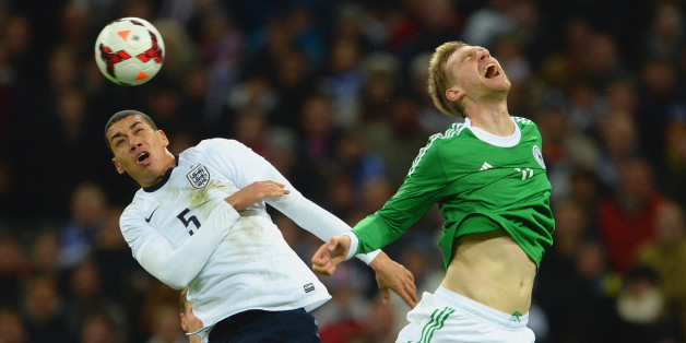 LONDON, ENGLAND - NOVEMBER 19: Chris Smalling of England and Per Mertesacker of Germany battle for the ball during the International Friendly match between England and Germany at Wembley Stadium on November 19, 2013 in London, England. (Photo by Michael Regan - The FA/The FA via Getty Images)