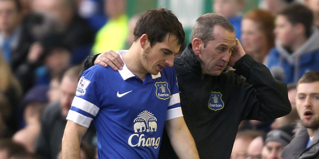 Everton's Leighton Baines is helped from the field of play after suffering an injury