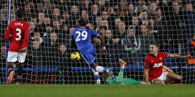 Chelsea's Cameroonian striker Samuel Eto'o (C) scores their second goal past Manchester United's Spanish goalkeeper David de Gea (2R) during the English Premier League football match between Chelsea and Manchester United at Stamford Bridge in London on January 19, 2014. AFP PHOTO / ADRIAN DENNIS
RESTRICTED TO EDITORIAL USE. No use with unauthorized audio, video, data, fixture lists, club/league logos or live services. Online in-match use limited to 45 images, no video emulation. No use in betting, games or single club/league/player publications. (Photo credit should read ADRIAN DENNIS/AFP/Getty Images)