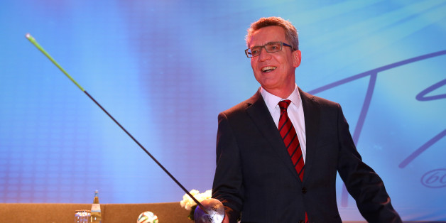 TAUBERBISCHOFSHEIM, GERMANY - JANUARY 10: German Interior Minister Thomas de Maiziere poses with a foil during IOC President Thomas Bach's 60th Birthday party at Stadthalle on January 10, 2014 in Tauberbischofsheim, Germany. (Photo by Alexander Hassenstein/Bongarts/Getty Images)