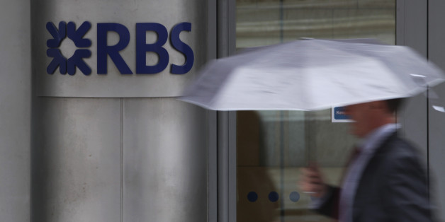 A pedestrian passes a sign outside the headquarters of the Royal Bank of Scotland Group Plc (RBS) in London, U.K., on Wednesday, July 18, 2012. The U.K. financial regulator said it's investigating seven lenders over attempts to manipulate interbank offered rates as lawmakers criticized it for not opening the probe earlier. Photographer: Chris Ratcliffe/Bloomberg via Getty Images