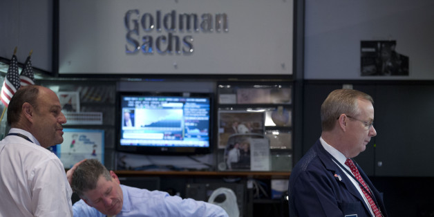 Traders work at the Goldman Sachs Group Inc. booth on the floor of the New York Stock Exchange (NYSE) in New York, U.S., on Friday, Jan. 24, 2014. U.S. stocks fell, pushing the Dow Jones Industrial Average to the biggest weekly decline since June 2012, as equities slumped worldwide amid a selloff in emerging-market currencies. Photographer: Jin Lee/Bloomberg via Getty Images