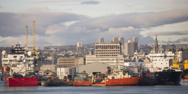 Vessels sit docked at Aberdeen Harbour, operated by the Aberdeen Harbour Board, as the city skyline is seen beyond in Aberdeen, U.K., on Thursday, Dec. 12, 2013. A report showed U.K. exports fell 1.3 percent in October from the previous month, while imports dropped 1.9 percent. Photographer: Simon Dawson/Bloomberg via Getty Images