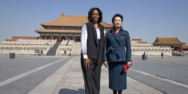 US First Lady Michelle Obama (L) and Peng Liyuan, wife of Chinese President Xi Jinping pose for photographers as they visit the Forbidden City in Beijing on March 21, 2014. Michelle Obama arrived in Beijing with her mother and daughters to kick off a seven-day, three-city tour where she will focus on education and cultural exchange. AFP PHOTO / POOL (Photo credit should read ANDY WONG/AFP/Getty Images)