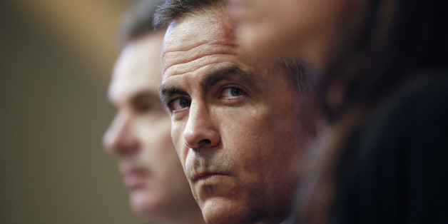 Mark Carney, governor of the Bank of England, center, pauses during the bank's quarterly inflation report news conference in London, U.K., on Wednesday, Aug. 13, 2014. Carney pledged that Bank of England officials won't rush to raise interest rates as he highlighted overseas risks to Britain's recovery and the weakness of wages. Photographer: Simon Dawson/Bloomberg via Getty Images