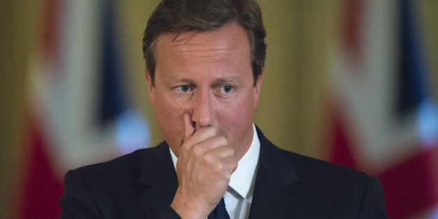 Prime Minister David Cameron pauses during a news conference in Downing Street, central London.