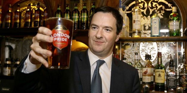 Chancellor of the Exchequer George Osborne holds a pint of beer during a visit to officially re-open The Red Lion pub, following a major refurbishment in Whitehall, central London.
