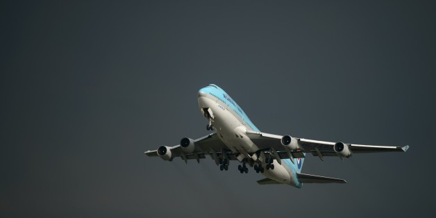 In a photo taken on August 26, 2014 a Korean Air Boeing 747 aircraft takes off before storm clouds at Gimpo airport, south of Seoul. South Korea's international air passenger traffic grew more than 10 percent in July from a year earlier with the number of international air passengers to and from South Korea at 5.13 million, up 10.6 percent from the previous year, according to the Ministry of Land, Infrastructure and Transport. AFP PHOTO / Ed Jones (Photo credit should read ED JONES/AFP/Ge