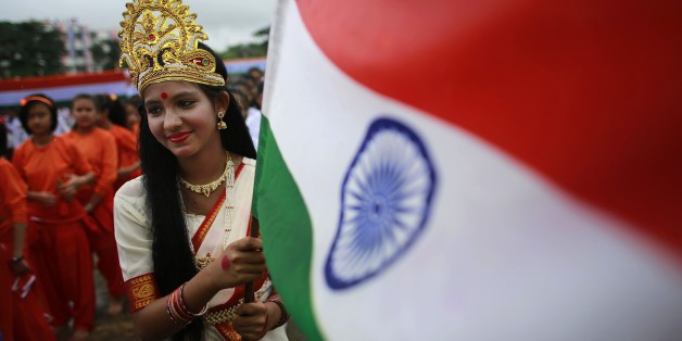 A school student dressed as "Mother India" holds an Indian flag during Independence Day celebrations in Gauhati, India, Friday Aug. 15 2014. India celebrates its 1947 independence from British colonial rule on Aug. 15. (AP Photo/Anupam Nath)