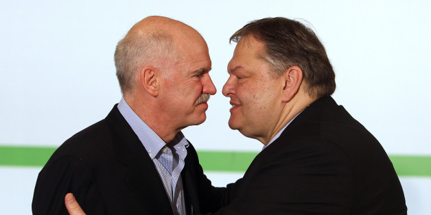 Former Greek Prime Minister George Papandreou, left, and Greek Finance Minister Evangelos Venizelos kiss each other during the hand over-ceremony of the PASOK party in Athens, Monday, March 19, 2012. Venizelos will submit his official resignation on Monday after being elected to head the majority Socialist party, replacing George Papandreou, as Greece heads into early general elections. (AP Photo/Thanassis Stavrakis)