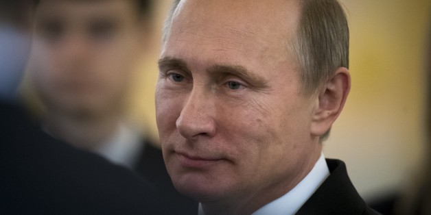 Russian President Vladimir Putin speaks to ambassadors in the Alexander Hall after a ceremony of presentation of credentials by foreign ambassadors in the Grand Kremlin Palace in Moscow, Russia, Wednesday, Nov. 19, 2014. Russia's foreign policy chief on Wednesday claimed that Ukraine's decision to freeze budget payments to the eastern rebel-held territories could be a precursor to a military onslaught. (AP Photo/Alexander Zemlianichenko, Pool)