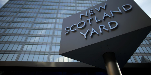 A sign rotates outside New Scotland Yard, the headquarters building of London's Metropolitan Police force in central London, Tuesday, Oct. 30, 2012. London's police force says it will move from its headquarters at New Scotland Yard as it faces making budget cuts of more than 500 million pounds ($800 million). Deputy Commissioner Craig Mackey told the mayor's office Tuesday that it plans to save 6.5 million pounds per year by moving to a smaller building. (AP Photo/Matt Dunham)
