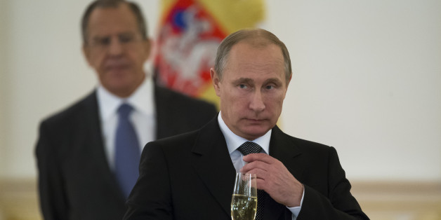 FILE In this file photo taken Wednesday, Nov. 19, 2014, Russian President Vladimir Putin prepare to toast with ambassadors in the Alexander Hall after a ceremony of presentation of credentials by foreign ambassadors in the Grand Kremlin Palace in Moscow, Russia. Vladimir Putin says he will not remain Russiaâs president for life, but will step down in line with the Russian constitution no later than 2024. Staying beyond that would be âdetrimental for the country and I donât need