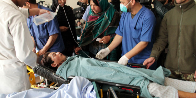 KABUL, AFGHANISTAN - NOVEMBER 24: An Afghan child who were injured in a suicide bomb attack targeted a volleyball match, receives medical treatment in a hospital, Kabul, Afghanistan, 24 November 2014. At least 45 people were killed and nearly 56 others injured when a suicide bomber attacked a volleyball match in Afghanistan. (Photo by Haroon Sabawoon/Anadolu Agency/Getty Images)