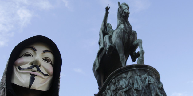 A demonstrator against the Anti-Counterfeiting Trade Agreement, or ACTA, wearing a mask shouts slogans in front of the monument of late Serbian Duke Mihailo Obrenovic, in downtown Belgrade, Serbia, Saturday, Feb. 25, 2012. Several hundred gathered to denounce ACTA agreement. (AP Photo/Darko Vojinovic)