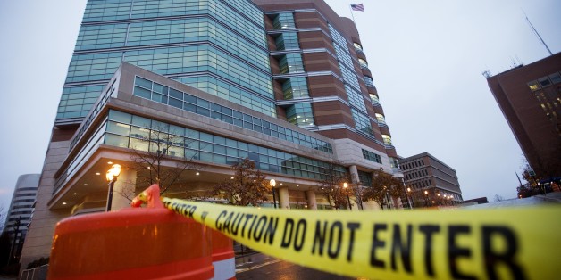 Barricades line the exterior of the Buzz Westfall Justice Center where a grand jury is expected to convene Monday to consider possible charges against the police officer who fatally shot Michael Brown in nearby Ferguson, Sunday, Nov. 23, 2014, in Clayton, Mo. Ferguson and the St. Louis region are on edge in anticipation of the announcement by a grand jury whether to criminally charge Officer Darren Wilson in the killing of 18-year-old Michael Brown. (AP Photo/David Goldman)