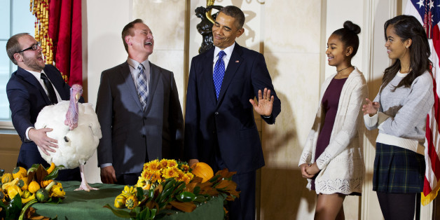 President Barack Obama gestures that his daughters Sasha, second from right, and Malia, right, would rather pass on touching "Cheese," the turkey during a ceremony at the White House in Washington, Wednesday, Nov. 26, 2014, where the president traditionally pardons turkeys saving them from the dinner table. Standing from left are Cole Cooper and his father Gary Cooper, chairman of the National Turkey Federation. (AP Photo/Jacquelyn Martin)