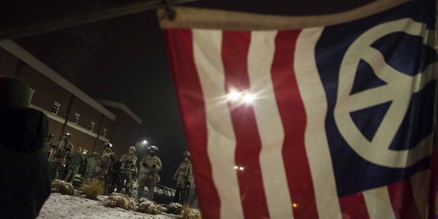 FERGUSON, MO - NOVEMBER 26: Members of Missouri National Guard are deployed outside the Ferguson Police Department during continued demonstrations after the Grand Jury did not indict white Police Officer Darren Wilson in the shooting death of black 18-year old Michael Brown in Ferguson, Mo. on November 26, 2014. (Photo by Samuel Corum/Anadolu Agency/Getty Images)