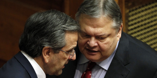 Greek Prime Minister Antonis Samaras, left, speaks with Socialist Leader Evangelos Venizelos at the Parliament during a debate on the new government's policy agenda before staging a vote of confidence in Athens, late Sunday July 8, 2012. (AP Photo/Kostas Tsironis)