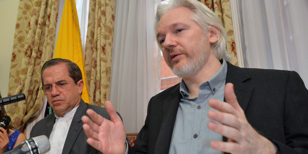 Ecuador's Foreign Minister Ricardo Patino, left, and WikiLeaks founder Julian Assange speak during a press conference inside the Ecuadorian Embassy in London, where he confirmed he "will be leaving the embassy soon", Monday Aug. 18, 2014. The Australian Assange fled to the Ecuadorian Embassy in 2012 to escape extradition to Sweden, where he is wanted over allegations of sex crimes. (AP Photo / John Stillwell, POOL)