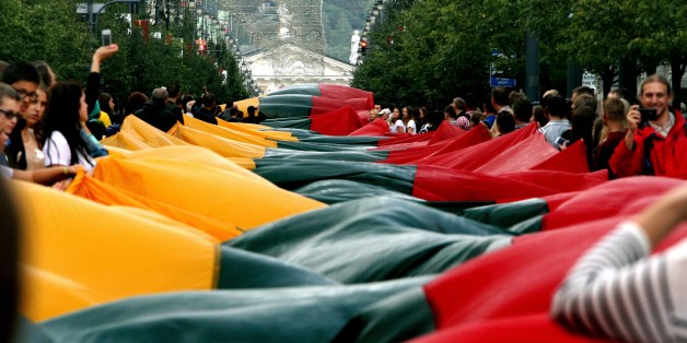 Lithuanians carry a 1000 metre long Lithuanian flag as they march during a celebration of the 25th anniversary of the Baltic Way in Vilnius on August 23, 2014. The Baltic states on Saturday marked 25 years since two million people joined hands in a landmark human chain linking up their capitals to demand freedom from the Soviet Union. AFP PHOTO / PETRAS MALUKAS (Photo credit should read PETRAS MALUKAS/AFP/Getty Images)