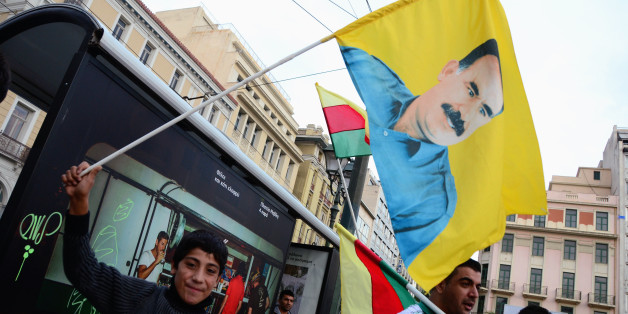 ATHENS, GREECE - 2014/10/04: A Kurdish demonstrator holds a flag with the image of Abdulah Otsalan president of PPK. Kurdish people living in Greece organized a demonstration in support of the Kurdish that fight ISIS insurgents at Iraq. (Photo by George Panagakis/Pacific Press/LightRocket via Getty Images)