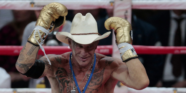 US actor Mickey Rourke celebrates his victory against his opponent Elliot Seymour of the United States, after their professional boxing match at the Luzhniki Stadium, Moscow, Friday, Nov. 28, 2014. Hollywood actor Mickey Rourke returned to the boxing ring Friday at the age of 62, defeating a fighter less than half his age in an exhibition bout. (AP Photo/Ivan Sekretarev)