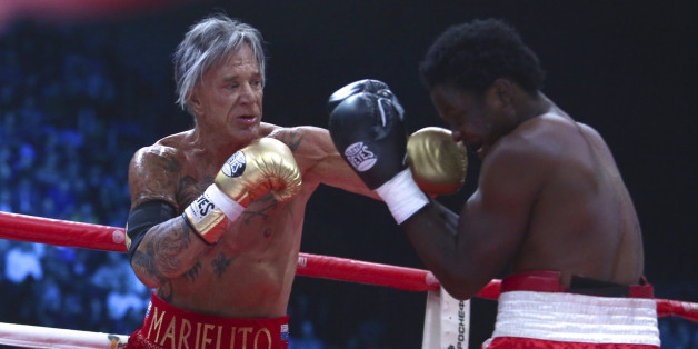 US actor Mickey Rourke, left, punches his opponent Elliot Seymour of the United States, during their professional boxing match at the Luzhniki Stadium, in Moscow, Russia, on Friday, Nov. 28, 2014. Hollywood actor Mickey Rourke returned to the boxing ring Friday at the age of 62, defeating a fighter less than half his age in an exhibition bout. (AP Photo/Denis Tyrin)