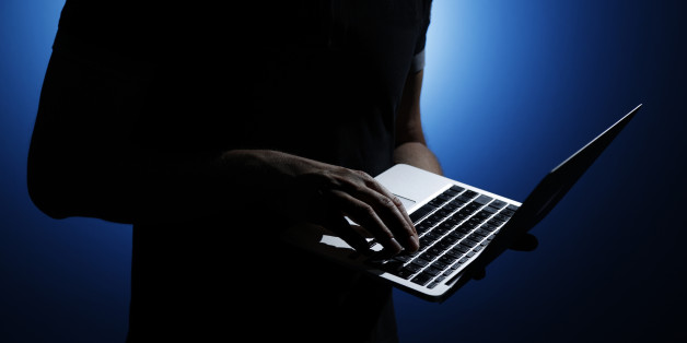 BERLIN, GERMANY - AUGUST 06: Silhouette of a man who is holding a laptop on August 06, 2014, in Berlin, Germany. (Photo by Thomas Trutschel/Photothek via Getty Images)***Local Caption***