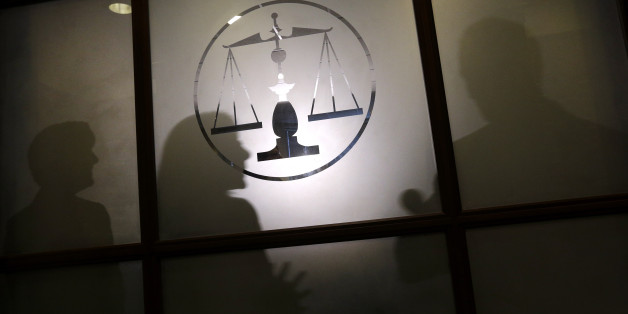 In this Oct. 30, 2013 photo, Annmarie Chiarini, from left, University of Maryland law professor Danielle Keats Citron and state Rep. Jon Cardin, D-Baltimore County, are silhouetted during a news conference to announce a bill that would criminalize "revenge porn" - the nonconsensual distribution of ex-significant others' nude photos on the Internet - in Baltimore. Chiarini got behind the cause after an ex-boyfriend took to the Internet to post nude images that she shared with him privately over t