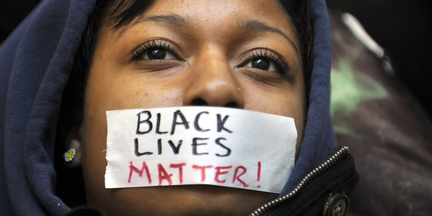 Penn State student Zaniya Joe wears a piece of tape over her mouth that says 'Black Lives Matter' during a Ferguson protest organized by a group of Penn State University students on Tuesday, Dec. 2, 2014, in University Park, Pa. (Nabil K. Mark/Centre Daily Times/TNS via Getty Images)