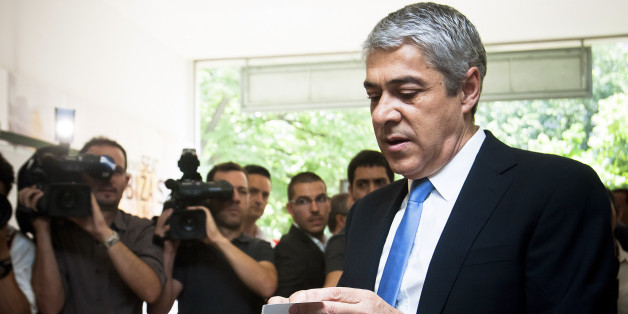 Jose Socrates, Portugal's prime minister, right, checks his ID card as he casts his ballot during the Portuguese elections in Lisbon, Portugal, on Sunday, June 5, 2011. Portuguese opposition leader Pedro Passos Coelho led Socialist Prime Minister Socrates in polls heading into today's election, with seat projections showing he may be able to forge a majority with another party. Photographer: Mario Proenca/Bloomberg via Getty Images