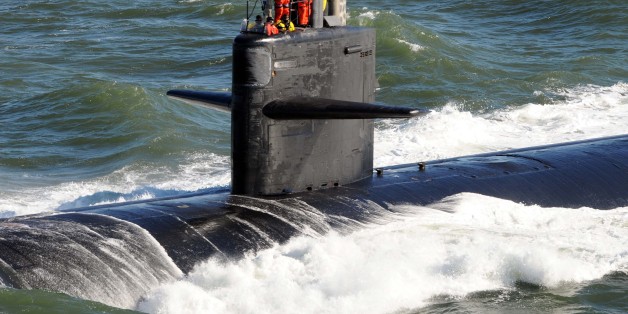 ATLANTIC OCEAN (Jan. 13, 2011) Sailors aboard the Los Angeles-class attack submarine USS Newport News (SSN 750) render honors as the submarine passes the aircraft carrier USS Enterprise (CVN 65). (U.S. Navy photo by Mass Communication Specialist 2nd Class Aaron Chase/Released)
