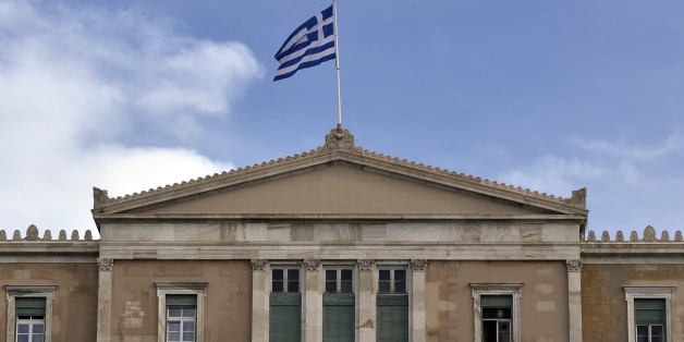 Workers work at the parliament building in Athens on November 18, 2014. In an effort to get voters back on side, the right-of-centre government has promised Greeks a complete end to years of painful rescue conditions that have become political poison in Athens. These efforts to end austerity in Greece, whose financial meltdown nearly destroyed the euro, come at a time of wider concern that the eurozone could fall back into recession. AFP PHOTO / LOUISA GOULIAMAKI (Photo credit should r