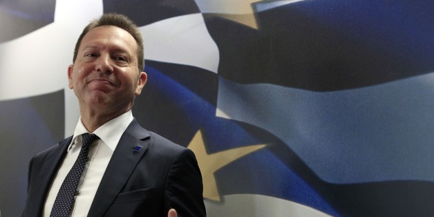 Greece's Finance Minister Yannis Stournaras attends for a news conference with European Union's Vice President and Competition Commissioner Joaquin Almunia in Athens, on Thursday, April 10, 2014. Buoyant Greek officials said the government had received strong interest for its first bond issue in four years, with Thursday's auction of five-year debt being about eight times oversubscribed â a sign of growing market confidence. "Greece has succeeded â and this is recognized by our most cr